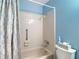 Clean and bright bathroom featuring a shower-tub combo with a decorative patterned shower curtain at 2011 Halidom Way # 0, Sun City Center, FL 33573