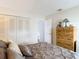 Bright bedroom featuring a neutral bed, large closet, and wooden dresser at 2011 Halidom Way # 0, Sun City Center, FL 33573