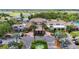 Aerial view of the clubhouse entrance featuring palm trees, manicured landscaping, water fountain, and ample parking at 2011 Halidom Way # 0, Sun City Center, FL 33573