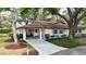 Charming single story home with an arched covered entrance, golf cart, and a well-manicured lawn at 2011 Halidom Way # 0, Sun City Center, FL 33573