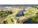 Beautiful aerial view of the community golf course with golfers and pristine landscaping at 2011 Halidom Way # 0, Sun City Center, FL 33573