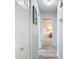 Hallway with white doors and light wood-look floors leads to the bedroom at 2011 Halidom Way # 0, Sun City Center, FL 33573