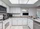 Updated kitchen with stainless steel appliances, granite countertops, and white cabinetry at 2011 Halidom Way # 0, Sun City Center, FL 33573