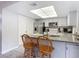 Cozy kitchen with granite countertops, stainless steel appliances, and light wood barstools at 2011 Halidom Way # 0, Sun City Center, FL 33573