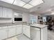 Updated kitchen featuring granite countertops, stainless steel dishwasher, and white cabinetry at 2011 Halidom Way # 0, Sun City Center, FL 33573