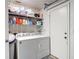 Functional laundry room with modern washer and dryer, storage shelves, and convenient access to the outdoors at 2011 Halidom Way # 0, Sun City Center, FL 33573