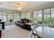 Sun-filled living room featuring a comfortable reclining sofa, large windows, and serene garden views at 2011 Halidom Way # 0, Sun City Center, FL 33573