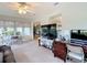 Bright living area with a large TV, desk area, and comfortable seating, perfect for relaxing or working at 2011 Halidom Way # 0, Sun City Center, FL 33573