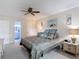 Spacious bedroom with ensuite bathroom, ceiling fan, and beach-themed decor for a relaxing retreat at 2011 Halidom Way # 0, Sun City Center, FL 33573