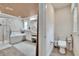 Luxurious bathroom with soaking tub, glass shower, double vanity, and adjacent toilet room at 2117 Lake Waters Pl, Lutz, FL 33558