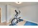 Bedroom with hardwood floors and exercise equipment at 2117 Lake Waters Pl, Lutz, FL 33558