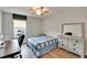 Comfortable bedroom with a plaid bedspread, desk, and dresser at 2117 Lake Waters Pl, Lutz, FL 33558