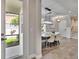 Light-filled dining room showcasing a modern chandelier, neutral decor, tile floors, and an entry view at 2117 Lake Waters Pl, Lutz, FL 33558