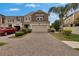 Charming two-story townhome featuring a brick paved driveway, attached garage, and well-manicured landscaping at 2117 Lake Waters Pl, Lutz, FL 33558