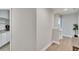 Upstairs hallway featuring hardwood floors, white walls, and stairway at 2117 Lake Waters Pl, Lutz, FL 33558