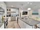Well-lit kitchen with stainless steel appliances, stone countertops, and white cabinetry that opens to the living area at 2117 Lake Waters Pl, Lutz, FL 33558