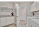 Well-organized laundry room with ample cabinets and counter space at 2117 Lake Waters Pl, Lutz, FL 33558