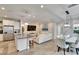 Bright, open-concept living space flowing into the dining area with modern lighting and neutral finishes at 2117 Lake Waters Pl, Lutz, FL 33558