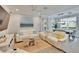 Bright living room with an adjacent dining area, comfortable sofas, a modern ceiling fan, and stylish decor at 2117 Lake Waters Pl, Lutz, FL 33558