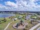 Aerial view of the community playground, green space, and lake at 2117 Lake Waters Pl, Lutz, FL 33558
