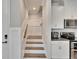 View of wooden stairs with white risers, adjacent to kitchen cabinets at 2117 Lake Waters Pl, Lutz, FL 33558