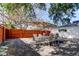Backyard featuring white home exterior, fenced-in yard, and mature trees at 2131 Cedar Dr, Dunedin, FL 34698