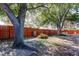Spacious backyard featuring a wood fence surrounding the property, mature trees, and shade at 2131 Cedar Dr, Dunedin, FL 34698