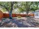 Large backyard with mature trees providing plenty of shade and a wood fence for privacy at 2131 Cedar Dr, Dunedin, FL 34698