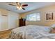 Bright bedroom with wood-look floors, ceiling fan, and closet at 2131 Cedar Dr, Dunedin, FL 34698