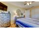Bedroom with hardwood floors, white closet doors, and two wooden dressers at 2131 Cedar Dr, Dunedin, FL 34698