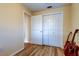 Bright bedroom with closet, featuring wood-look floors and neutral walls at 2131 Cedar Dr, Dunedin, FL 34698