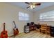 Bedroom features wood floor, two windows, and a fan at 2131 Cedar Dr, Dunedin, FL 34698