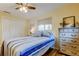 Bedroom with hardwood floors, white closet doors, and a rustic-style dresser at 2131 Cedar Dr, Dunedin, FL 34698