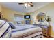 Bedroom featuring stylish furniture, ceiling fan, and a comfortably made bed at 2131 Cedar Dr, Dunedin, FL 34698