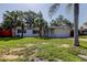 Attractive single-Gathering home with lush landscaping, blue shutters and an attached garage at 2131 Cedar Dr, Dunedin, FL 34698