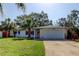 Charming single-story home featuring a well-manicured lawn and a two-car garage at 2131 Cedar Dr, Dunedin, FL 34698