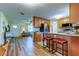 Open kitchen featuring stainless steel appliances, breakfast bar, and wood cabinets at 2131 Cedar Dr, Dunedin, FL 34698