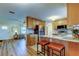 Bright kitchen featuring wood cabinets, granite countertops, stainless steel appliances, and bar seating area at 2131 Cedar Dr, Dunedin, FL 34698