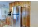 Stainless steel refrigerator and wood cabinets in an updated kitchen at 2131 Cedar Dr, Dunedin, FL 34698