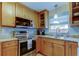 Featuring an updated kitchen with stainless steel appliances, granite countertops, and a double sink at 2131 Cedar Dr, Dunedin, FL 34698