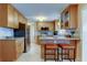 Updated kitchen with stainless appliances, granite counters, and breakfast bar with seating at 2131 Cedar Dr, Dunedin, FL 34698