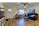 Comfortable living room with hardwood floors, a ceiling fan, and natural light from a window at 2131 Cedar Dr, Dunedin, FL 34698