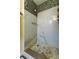 Elegant marble shower with mosaic tile accents at 2131 Cedar Dr, Dunedin, FL 34698
