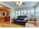 Bright sunroom showcasing seamless flow to the open kitchen and inviting seating at 2131 Cedar Dr, Dunedin, FL 34698