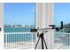 Balcony view with telescope overlooking waterfront and blue sky at 2171 E Vina Del Mar Blvd, St Pete Beach, FL 33706