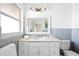 Bathroom featuring a single vanity, updated fixtures, and blue tile accents, creating a clean and modern space at 2171 E Vina Del Mar Blvd, St Pete Beach, FL 33706