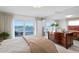 Bright bedroom with water views from private balcony, complemented by a spacious interior design at 2171 E Vina Del Mar Blvd, St Pete Beach, FL 33706