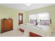 Bright bedroom features twin beds, natural light, a classic wood dresser, and a cozy, inviting atmosphere at 2171 E Vina Del Mar Blvd, St Pete Beach, FL 33706
