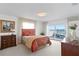 This bedroom features a serene water view and charming decor with a unique headboard and natural light at 2171 E Vina Del Mar Blvd, St Pete Beach, FL 33706