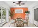Bright dining area with water views, glass table, and comfortable seating by the sliding door at 2171 E Vina Del Mar Blvd, St Pete Beach, FL 33706